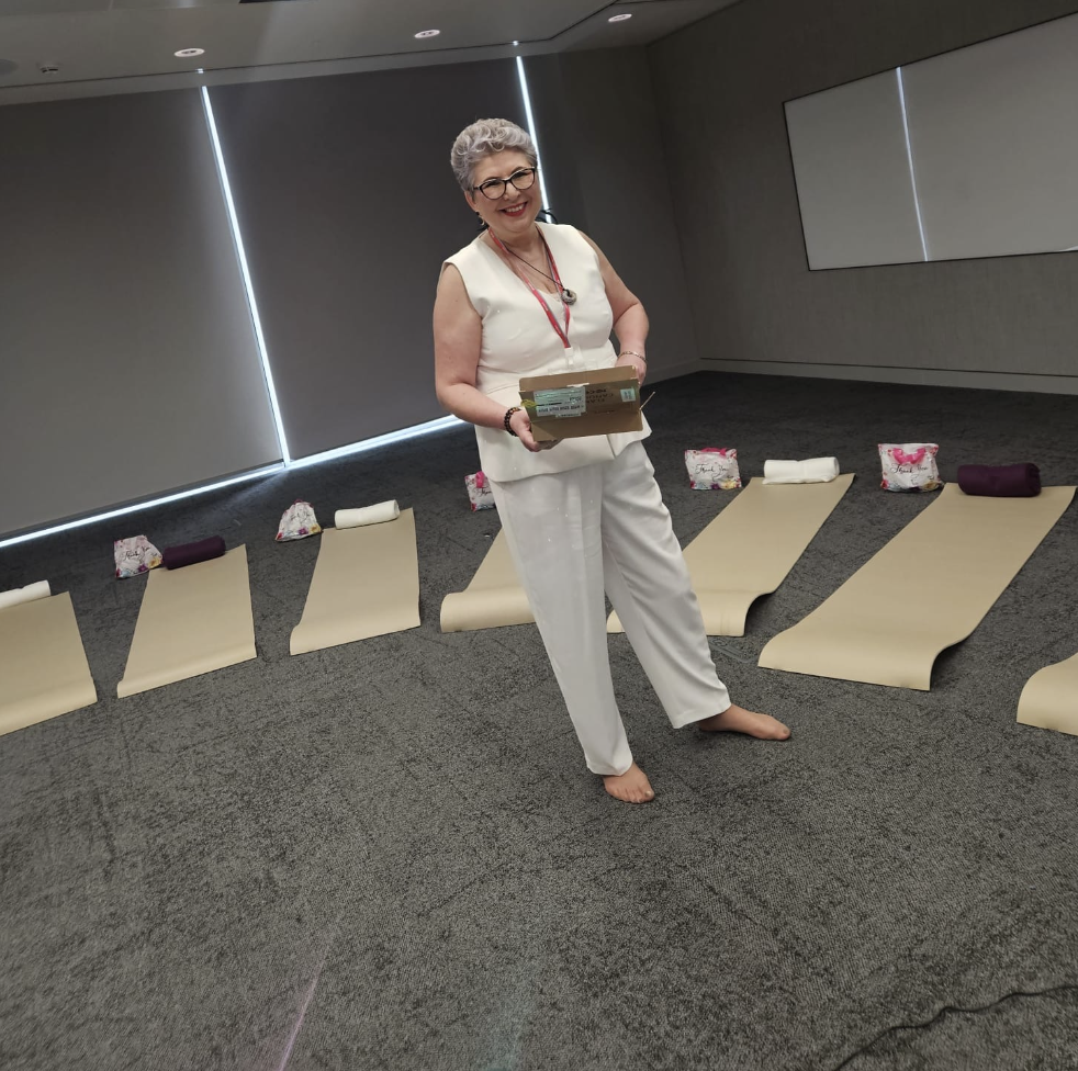 Jennifer Byrne setting up mats, bolsters and gift bags for a corporate group reset session